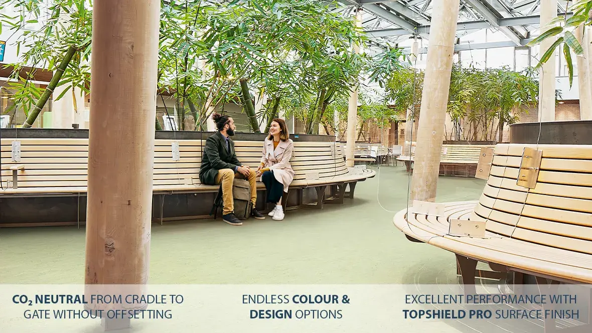 Marmoleum installed in a public setting featuring trees and a couple sitting on a bench