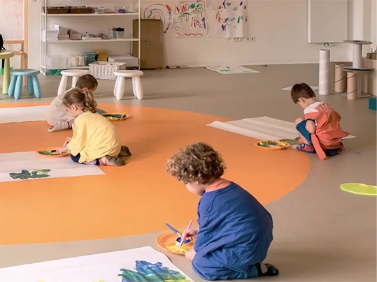 Children playing indoors on marmoleum Decibel 324735 | Forbo Flooring Systems