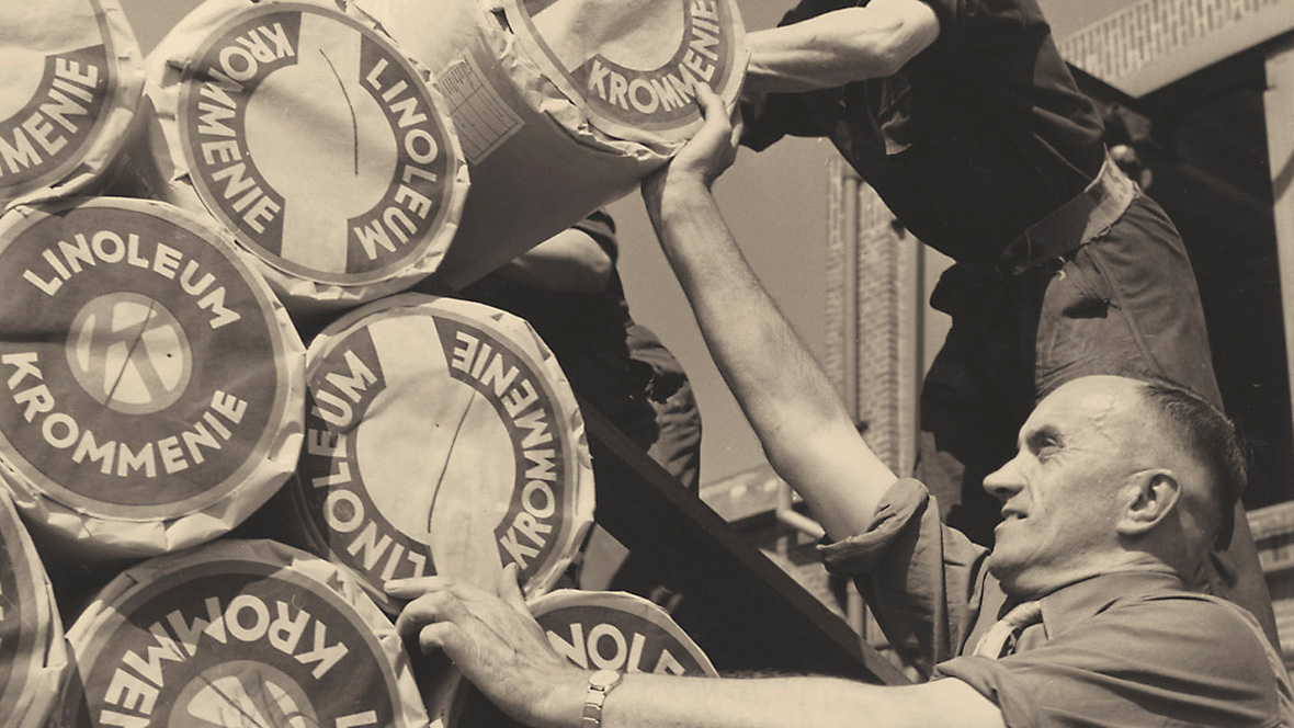 Archive photograph of Forbo employees stacking linoleum rolls. Archive photograph of Forbo employees stacking linoleum rolls.