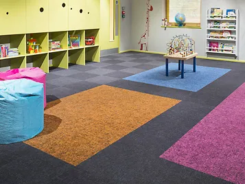 Flotex, the washable textile floor covering, in tile format in a kindergarten. A product line that has been part of the Forbo  product portfolio since the acquisition of Bonar Floors in 2008.