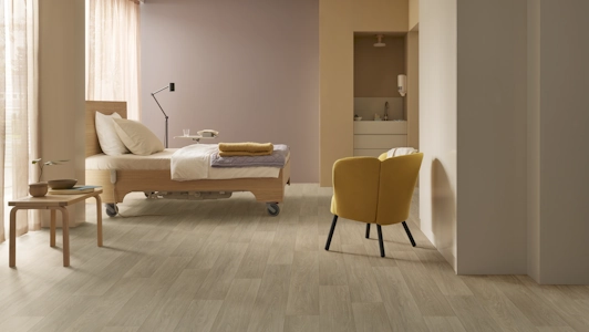 Eternal Next clear smooth oak in a hospital bedroom setting