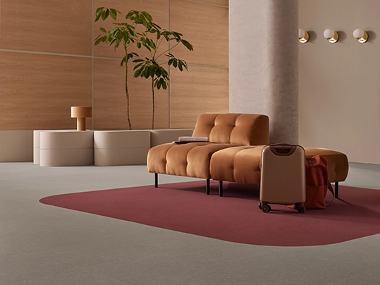 Flotex Colour in a hospitality setting with suitcase | Forbo Flooring Systems